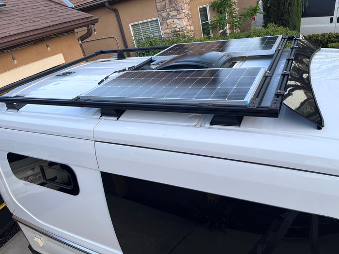 This white RV rental showcases two rooftop solar panels and a central vent system, ideal for off-grid adventures.