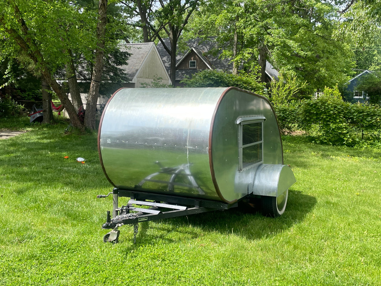 perfect for an RV rental. Michigan F258286 license plate.|Classic silver teardrop travel trailer