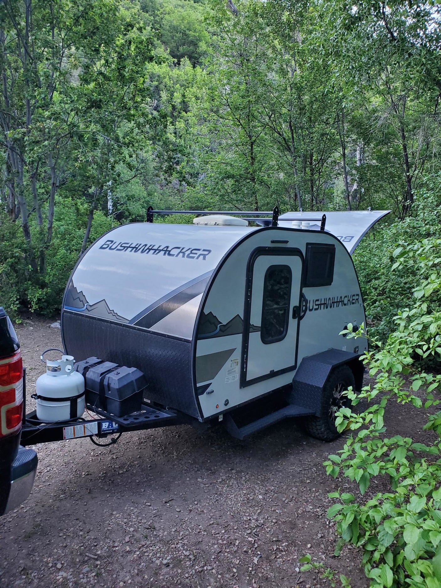 and tools laid out for outdoor cooking.|Explore this rv rental's compact outdoor kitchen: stove