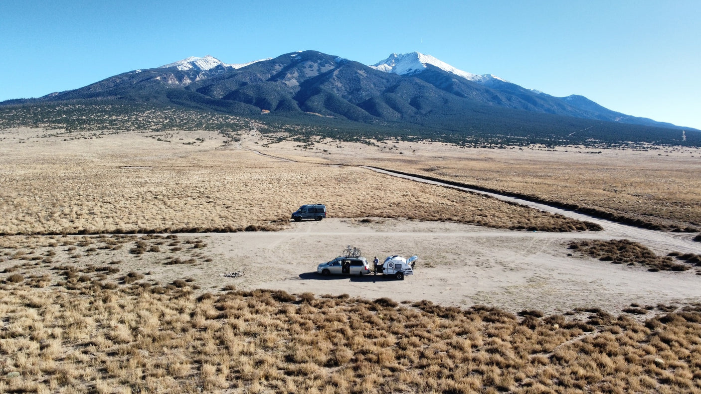 and a scenic window view. Perfect for compact adventures.|Inside a cozy RV rental camper with a bed