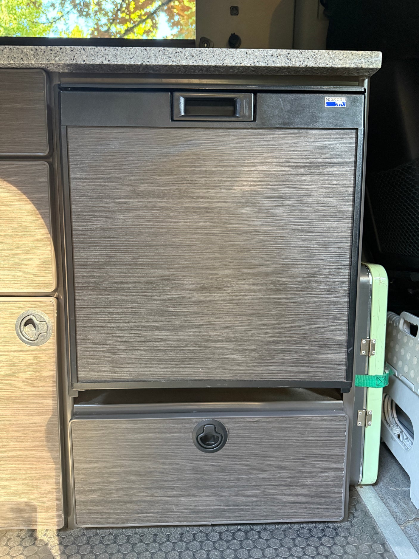 RV rental interior: Norcold refrigerator with textured door & lower storage drawer.
