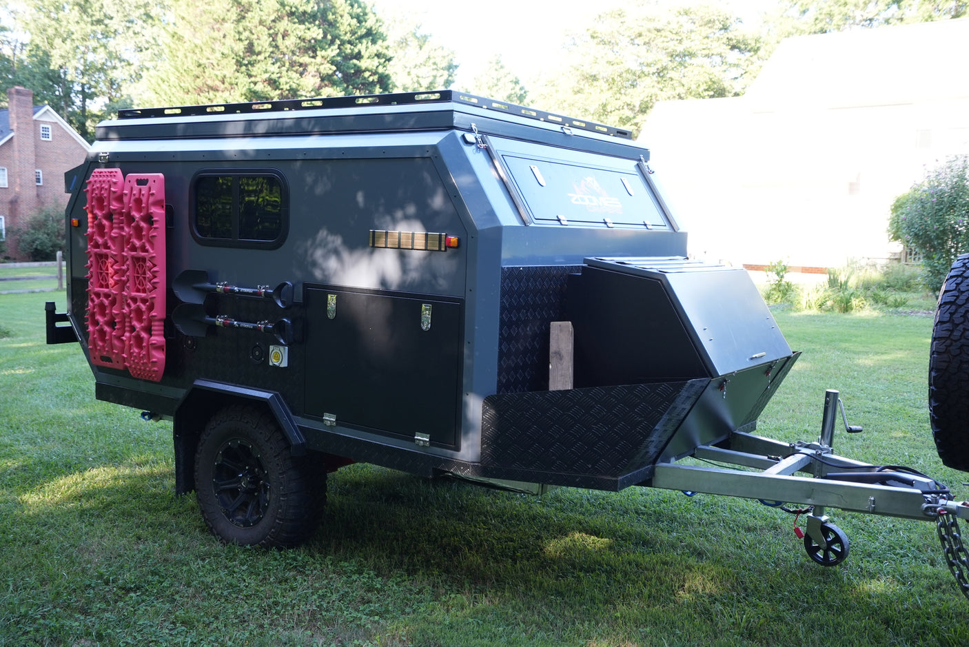 Explore off-road with this rugged camper trailer RV rental, equipped with recovery boards, shovels, and rooftop rack.