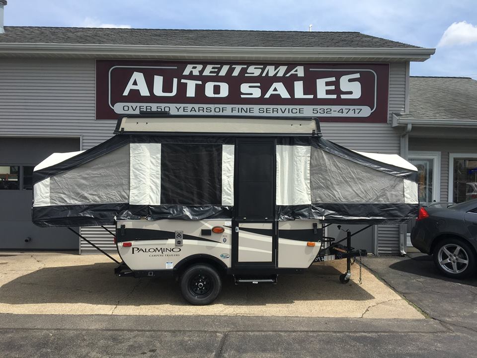 Pop-up camping trailer at Reitsma Auto Sales. Inquire about RV rental options here!|RV rental floor plan diagram: Features 42" & 54" bunks