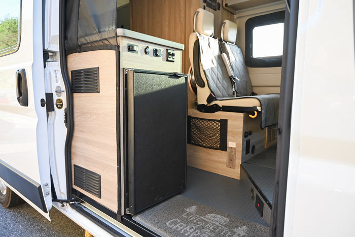 & controls near passenger seats.|Cozy RV rental interior featuring a yellow bed