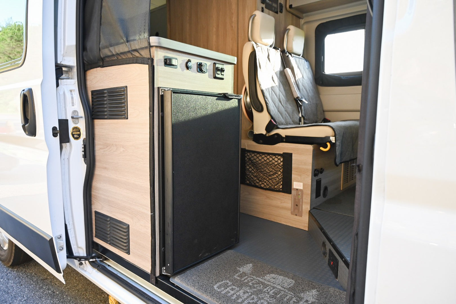 & controls near passenger seats.|Cozy RV rental interior featuring a yellow bed