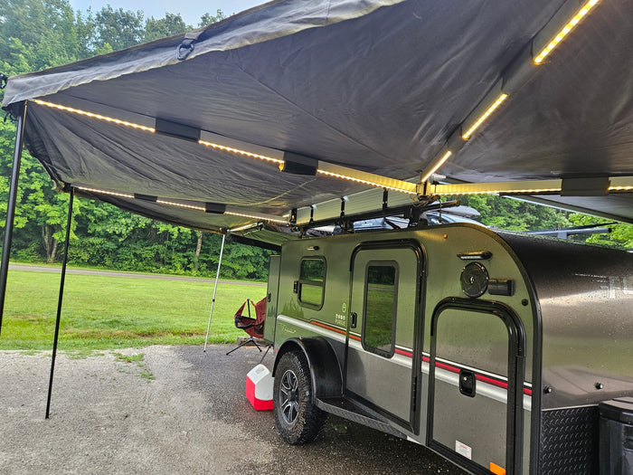 Enjoy an outdoor rv rental adventure! This teardrop travel trailer features an illuminated awning, ideal for cozy camping.
