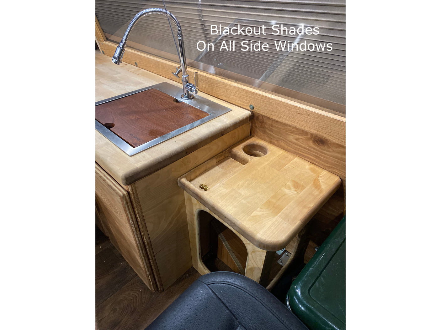 RV rental: wooden galley w/ sink, flexible faucet, & side table w/ cup holder. Blackout shades for privacy.