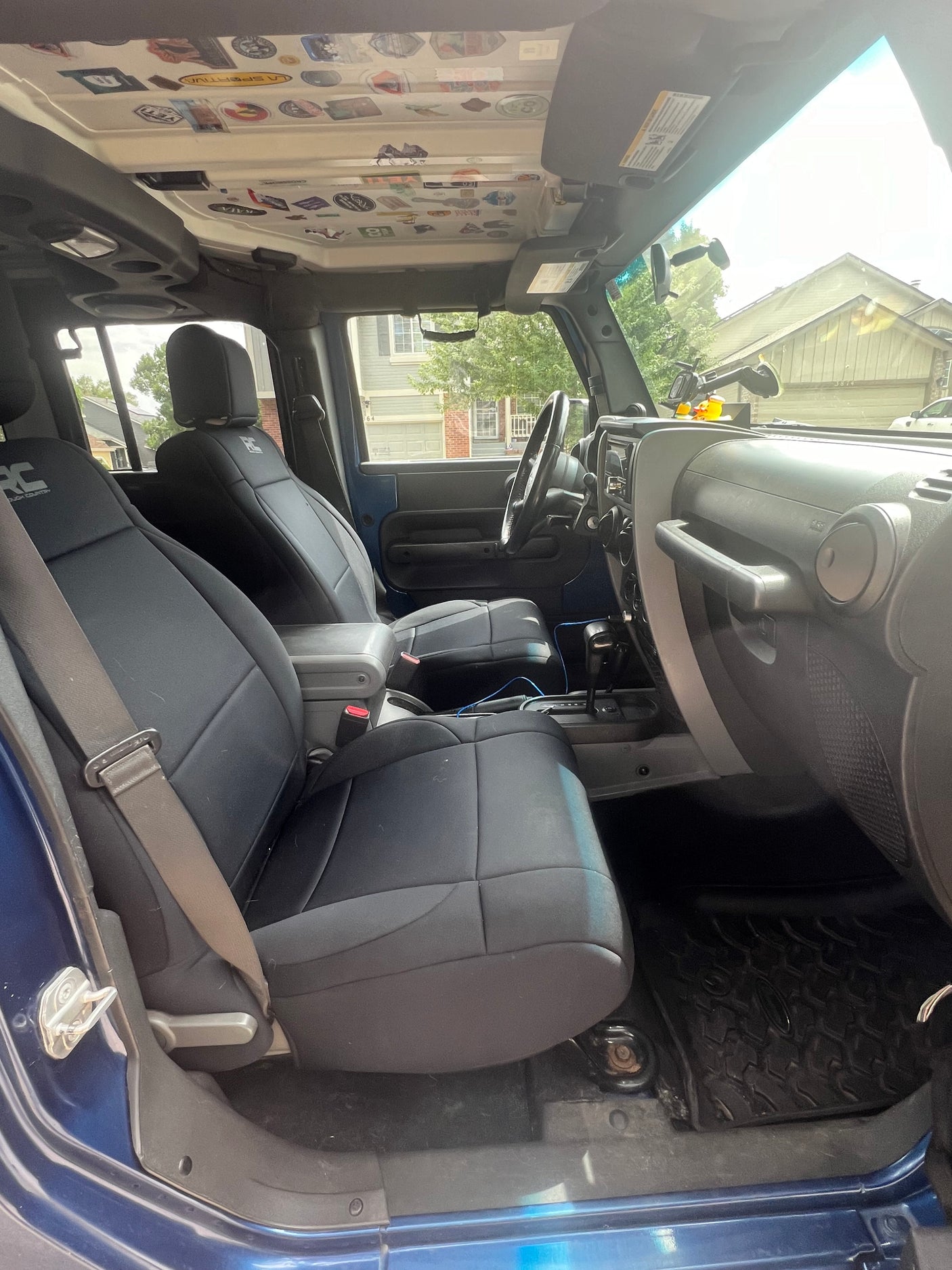 Modified Jeep interior showcasing custom seats and adventure stickers. Perfect for an rv rental getaway.