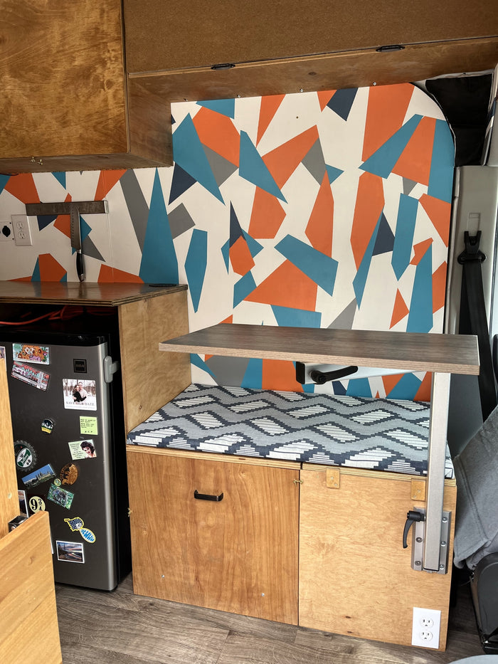 and a unique sticker collection.|Step into this custom-built **RV rental** camper van! Features a mobile workspace