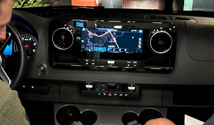 RV rental interior: A detailed view of the modern dashboard, featuring a large navigation screen and vehicle controls.