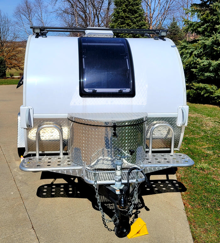parked on concrete. Ideal for an RV rental adventure.|Cozy RV rental bedroom with blue comforter