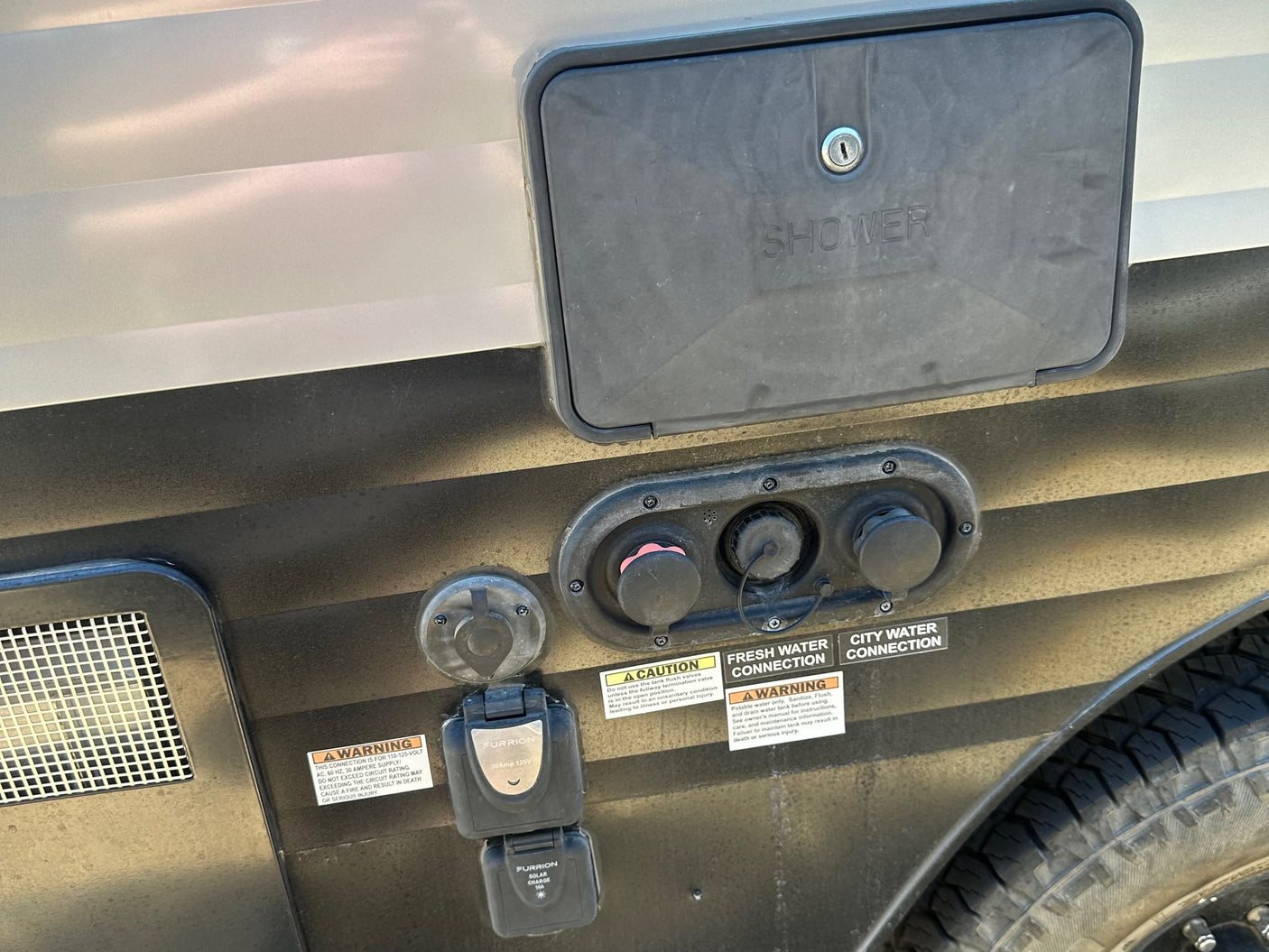 and shower pan. A small but functional space.|RV rental interior featuring a cozy bed
