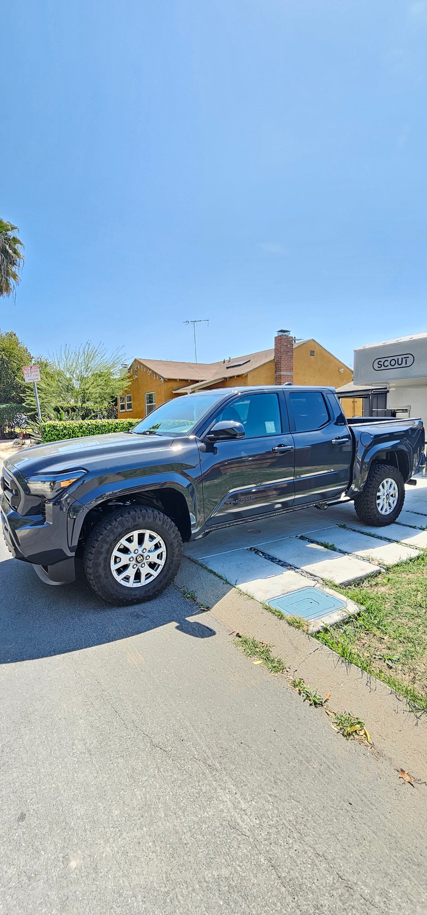 Dark grey Toyota Tacoma pickup with a Scout RV camper. Ready for overlanding or your next rv rental adventure.