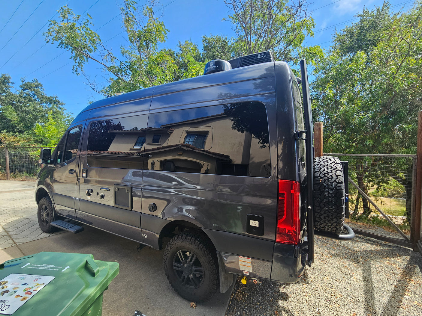 This dark grey camper van, equipped with roof AC & off-road tires, makes a great RV rental for adventures.