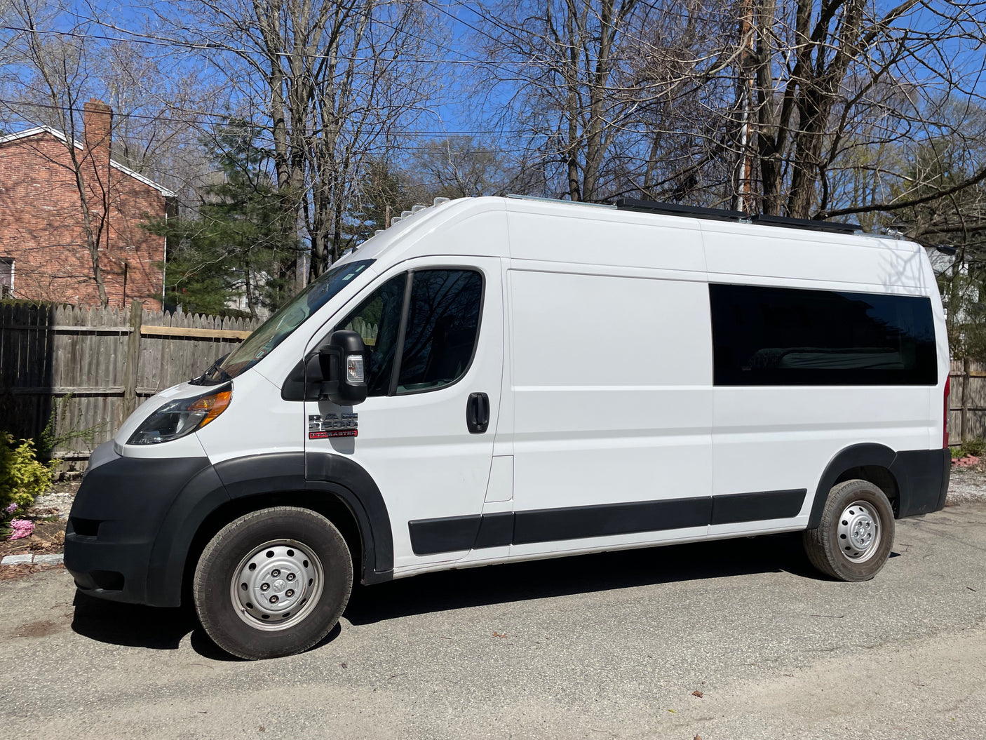 Explore in this white Ram ProMaster campervan, available for RV rental.