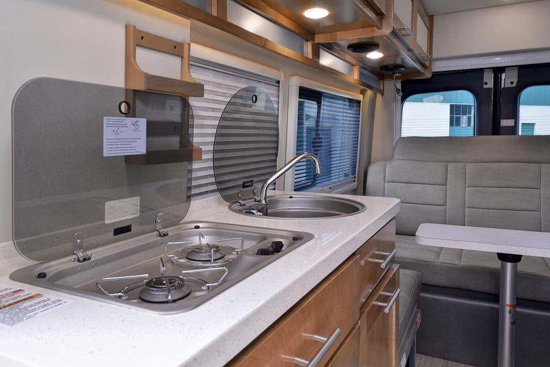 and clever storage for road trips.|Spacious RV rental interior featuring a gray U-shaped lounge
