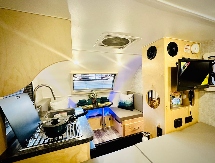 creating a perfect camping oasis.|White BMW X3 SUV tows a Little Guy teardrop camper