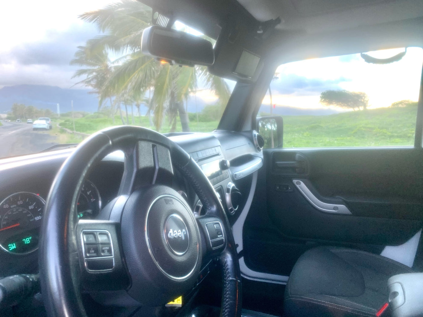 Inside a Jeep, perfect for an rv rental road trip! Enjoy tropical palm trees & mountain views from the driver's seat.