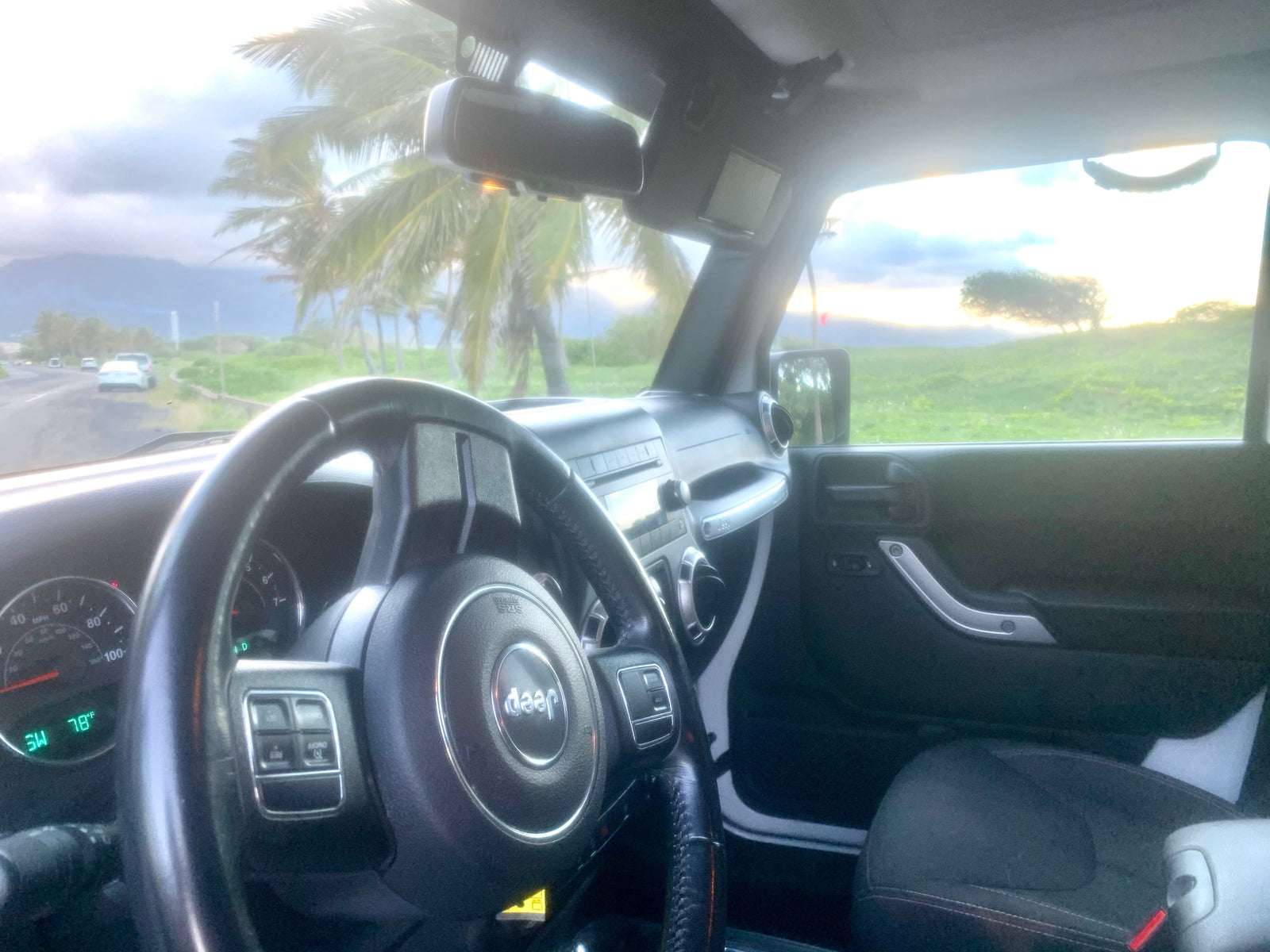 Inside a Jeep, perfect for an rv rental road trip! Enjoy tropical palm trees & mountain views from the driver's seat.