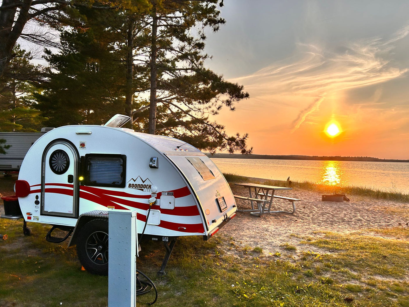 and practical amenities for travel.|Cozy rv rental: feet up on bed