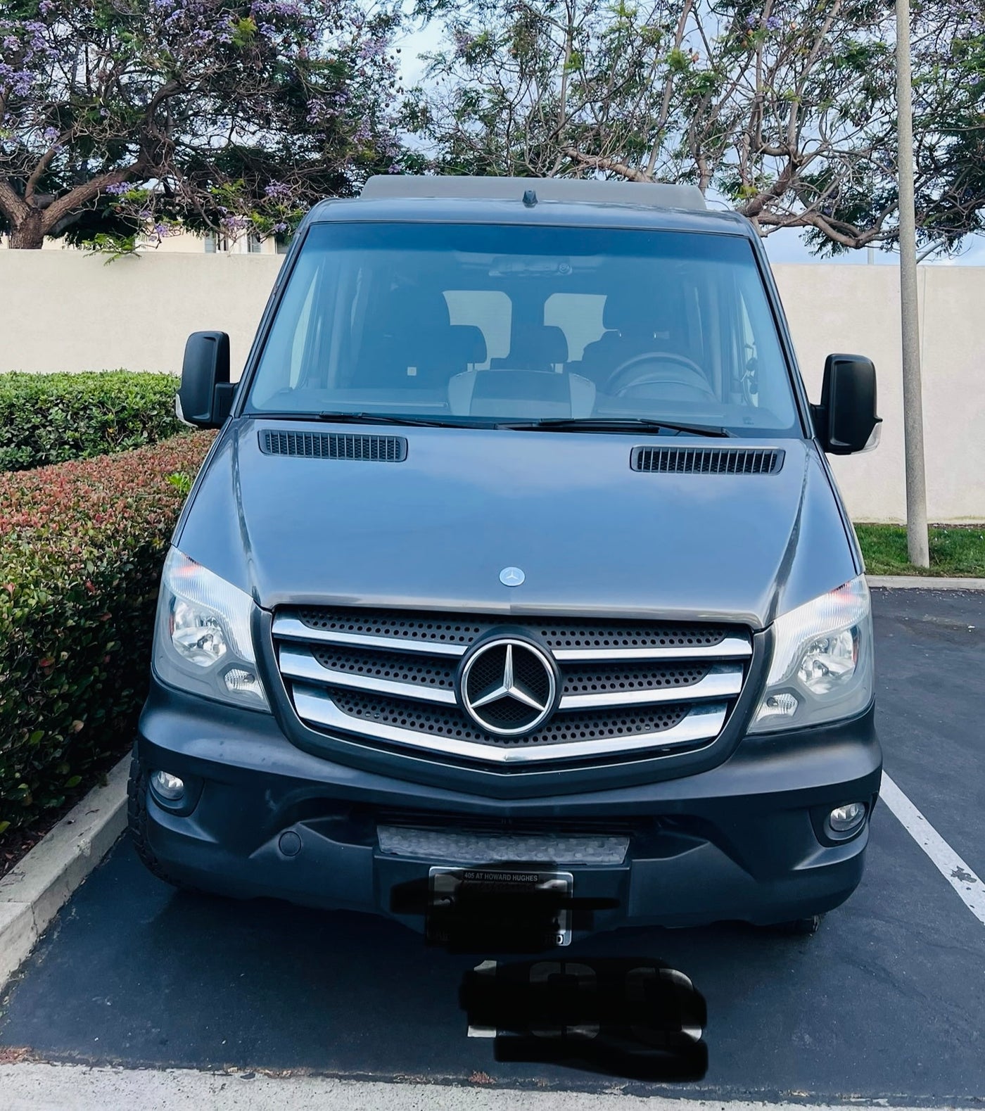 revealing the interior. Ideal RV rental for travel.|Front view of a dark gray Mercedes-Benz Sprinter van — photo 1