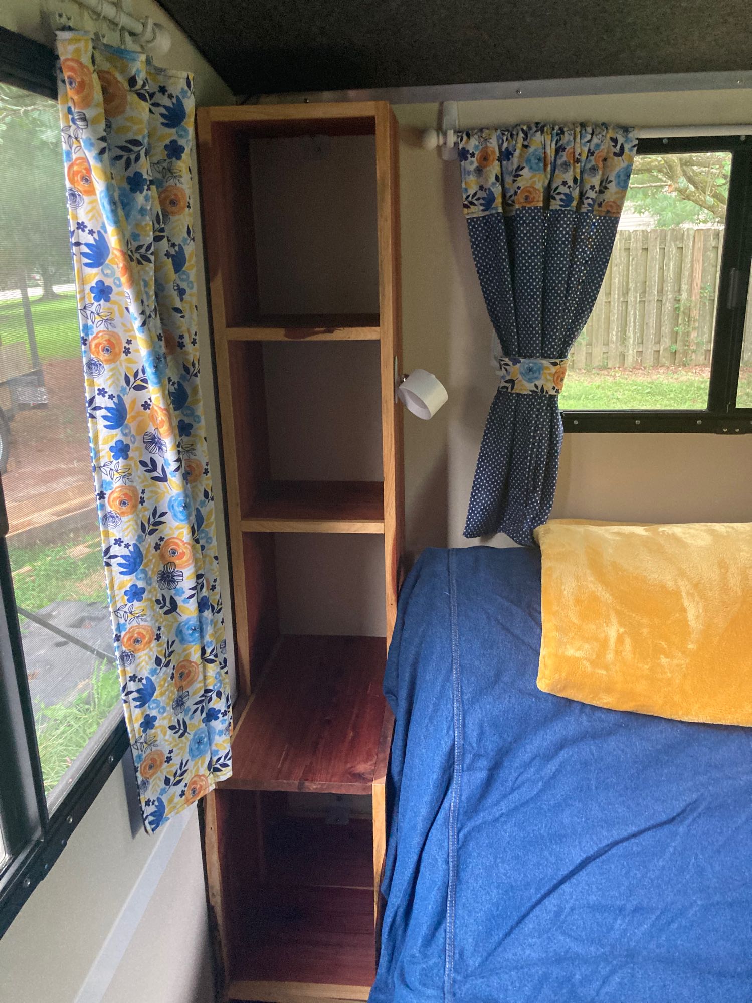 and a "LAUGH" pillow.|Inside an RV rental: a comfy bed