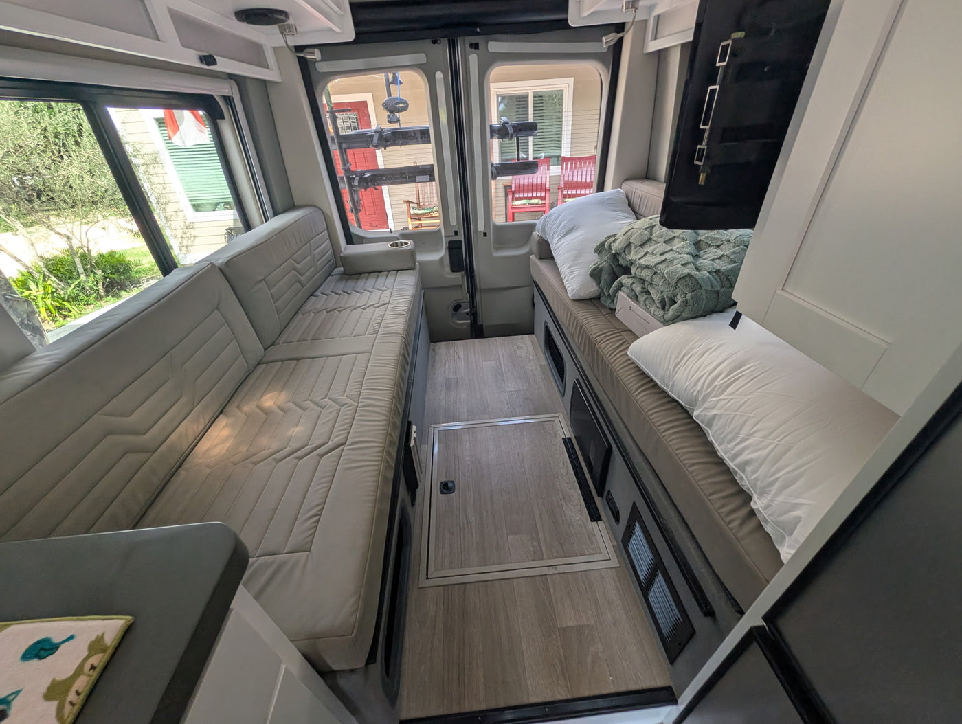 shown from the front with a unique mountain-themed license plate frame.|RV rental bathroom: compact wet bath with toilet — photo 10