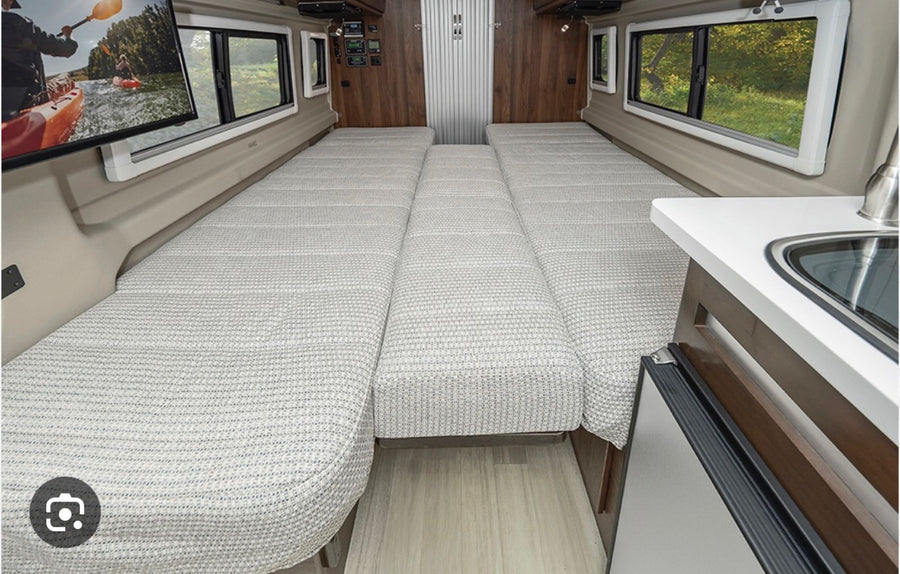 and overhead bed storage.|RV rental interior: twin beds