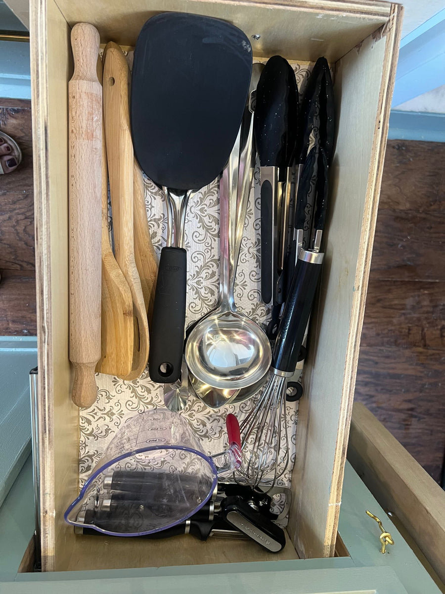 and soap dispenser.|An RV rental's clever interior: compact kitchen with sink