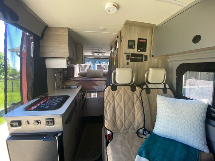 and dining.|Red pop-top RV rental by a tranquil lake and bare trees. Perfect for nature adventures.|Comfortable RV rental with a cozy pop-top sleeping area
