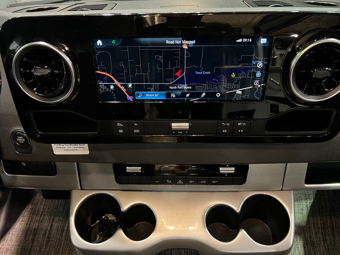 and front driving cockpit are visible in this campervan.|A well-appointed RV rental bedroom with two comfortable twin beds