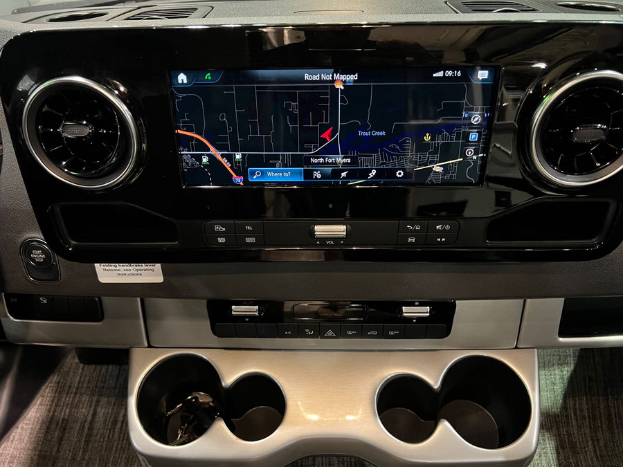 and front driving cockpit are visible in this campervan.|A well-appointed RV rental bedroom with two comfortable twin beds