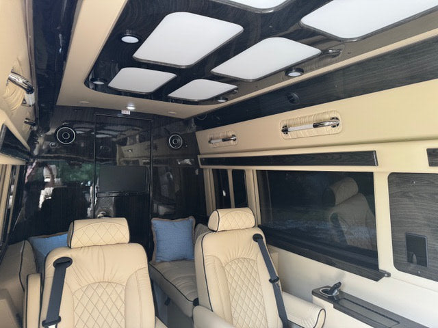 plush captain's chairs.|Inside a luxurious custom van rv rental