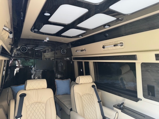 plush captain's chairs.|Inside a luxurious custom van rv rental
