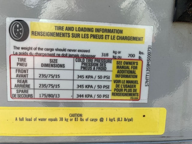 RV rental tire & loading info sticker details recommended tire pressure & max cargo weight for safe operation.