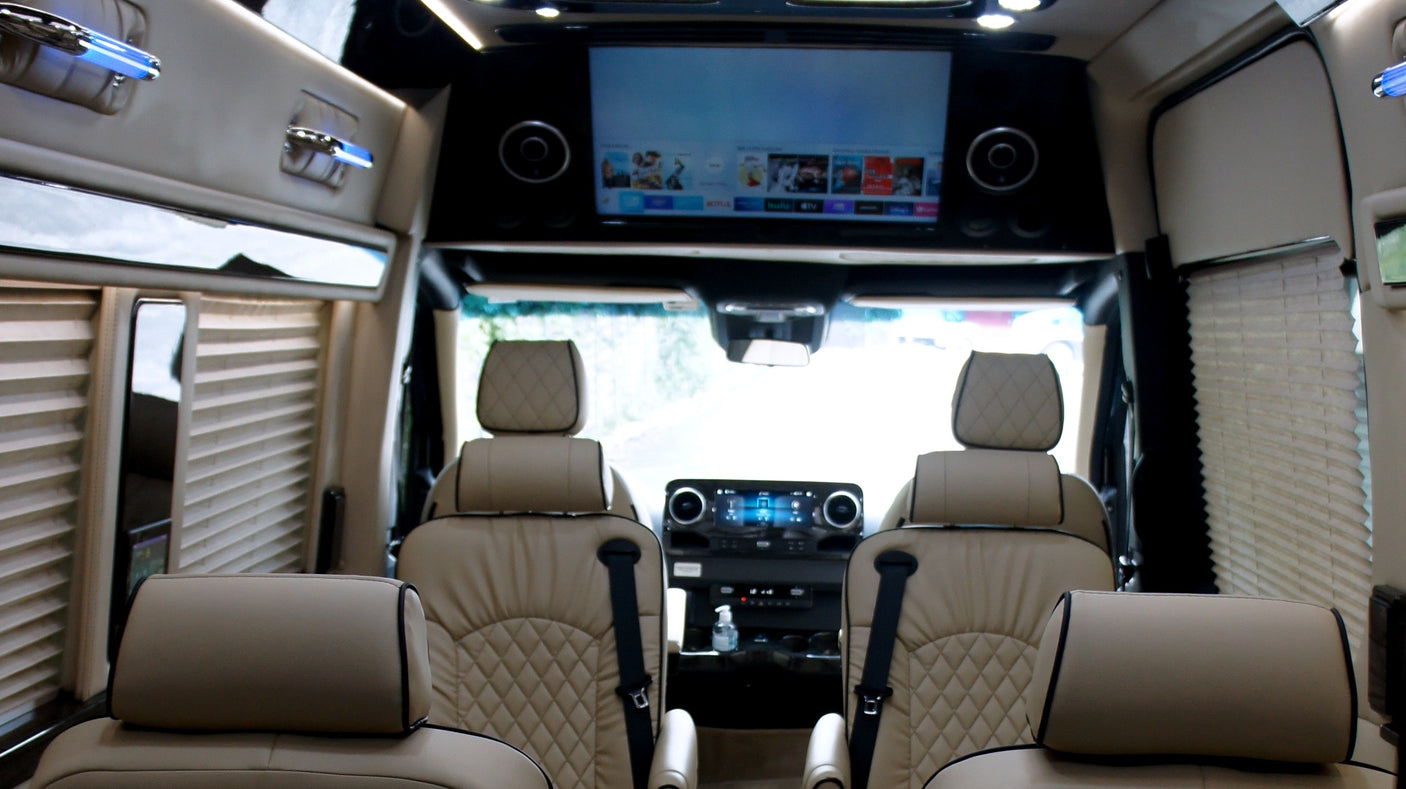 Experience premium rv rental comfort: plush leather interior, entertainment screen, and privacy blinds for your journey.