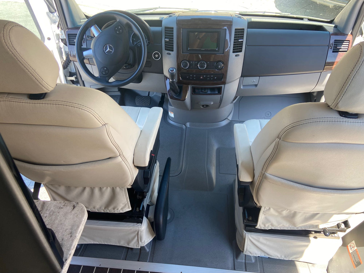 and comfortable seating. Ideal for your next adventure.|Inside an RV rental: a well-appointed kitchen with sink and two-burner stove — photo 7