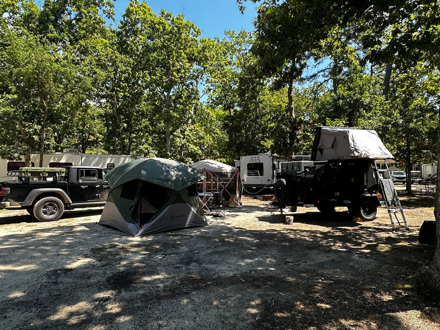 towed by a Jeep.|Sunny campsite featuring an RV (perfect for an rv rental)