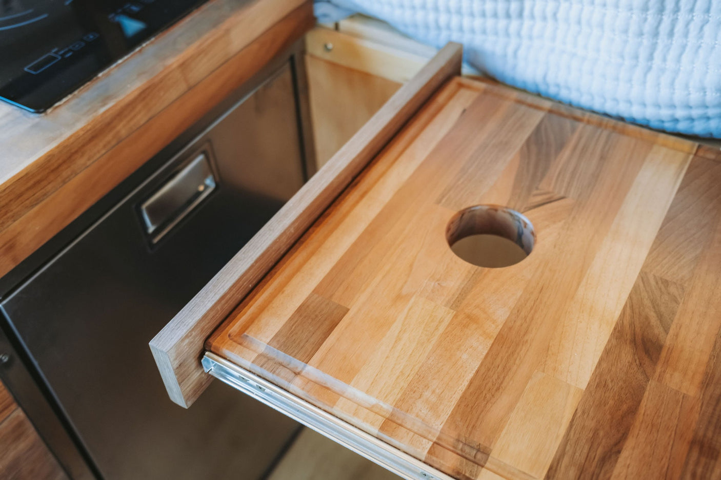 overlooking a scenic outdoor landscape.|A cozy RV rental camper van interior featuring a bed