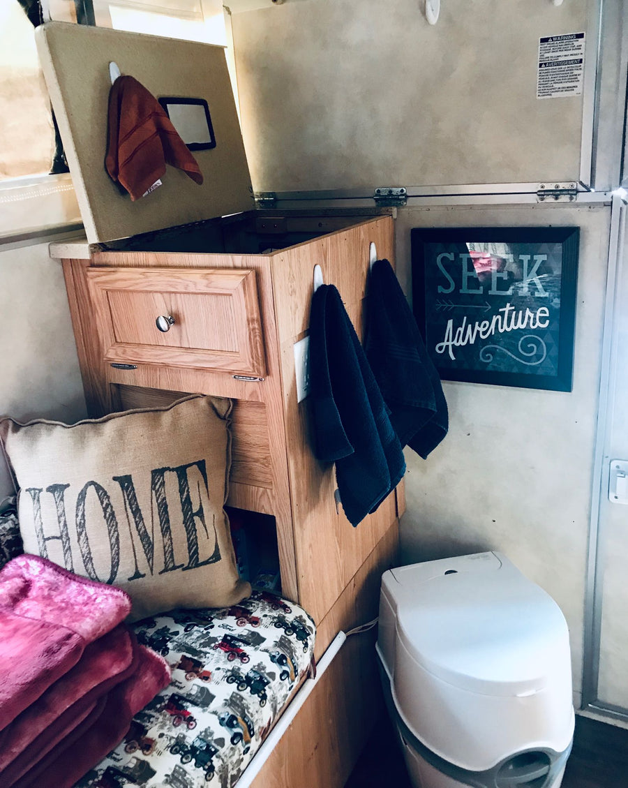 at a forest campsite with firewood. Perfect for outdoor adventures.|Cozy RV rental setup with clever storage
