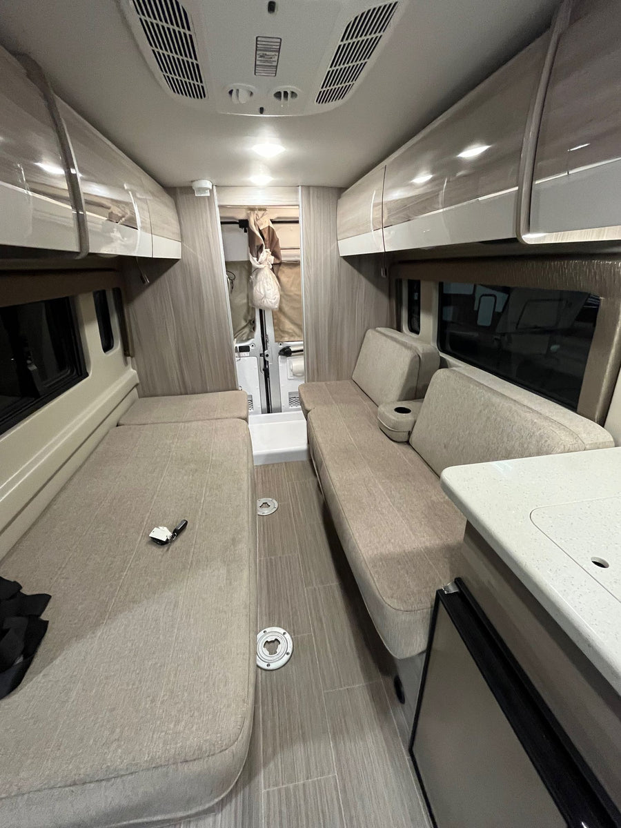 set against mountain views.|Modern RV rental kitchen with sink