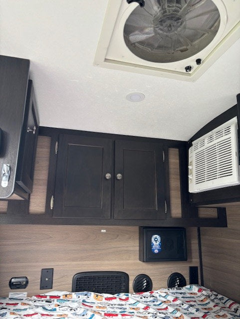 and cooler/fridge. Great for camping trips!|Cozy RV rental interior featuring a car-themed bed