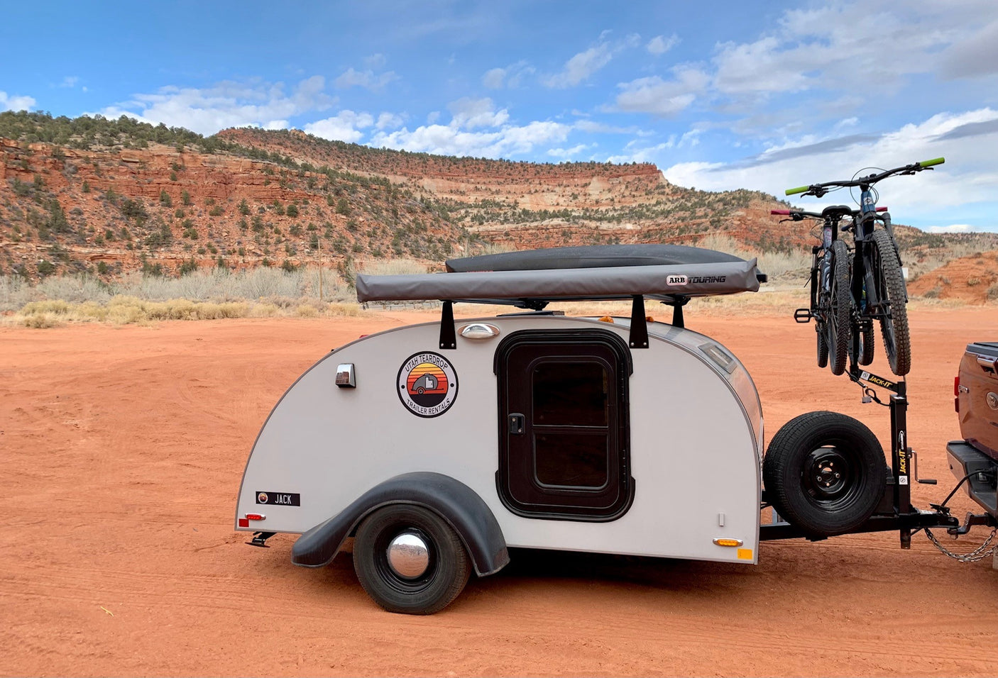This Utah Teardrop RV rental: 'Jack,' a compact trailer with bikes attached, is set for red rock desert adventures.