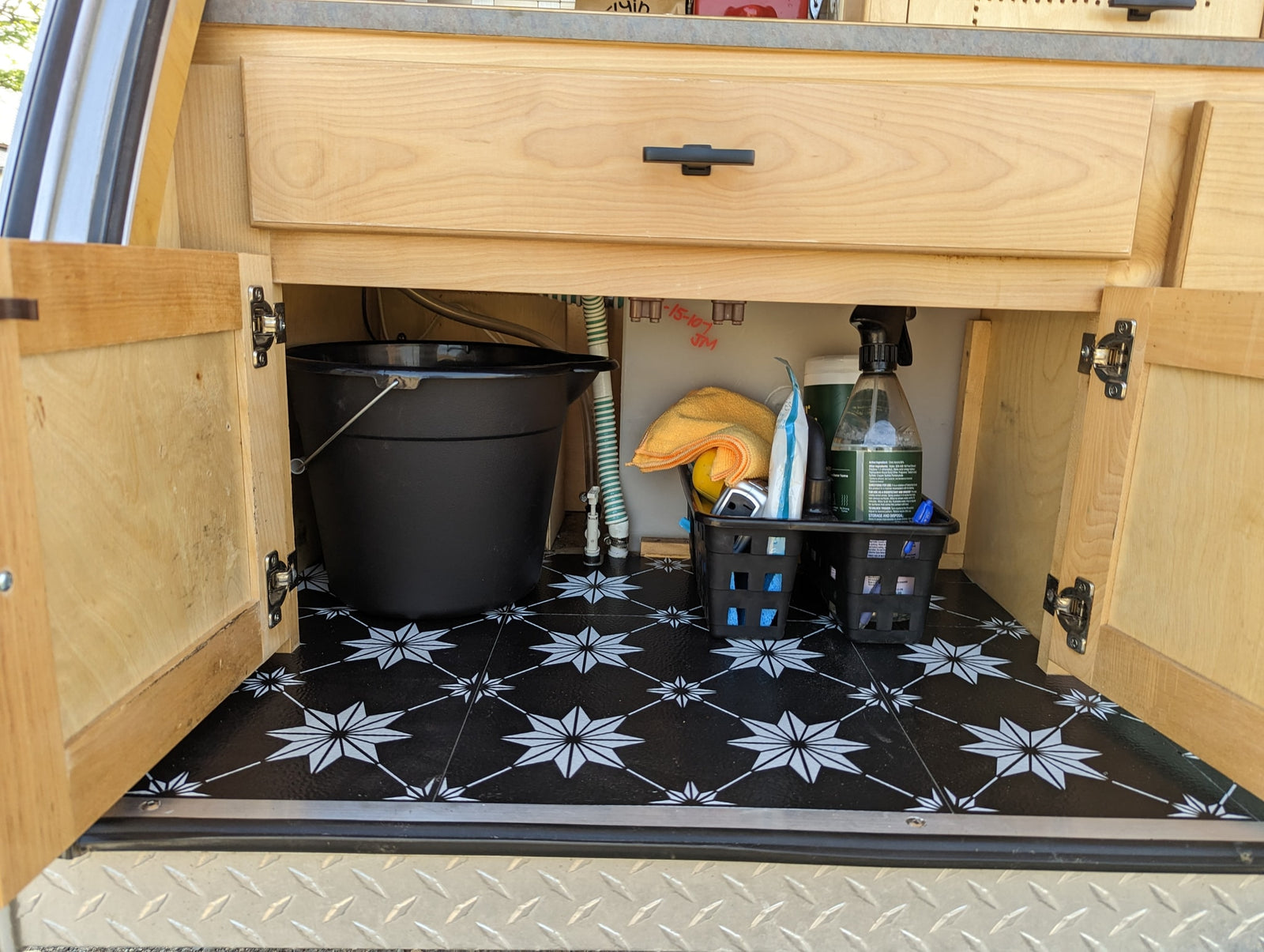 is ready for your next rv rental adventure in a scenic outdoor setting.|Compact rv rental teardrop camper kitchen featuring a sink