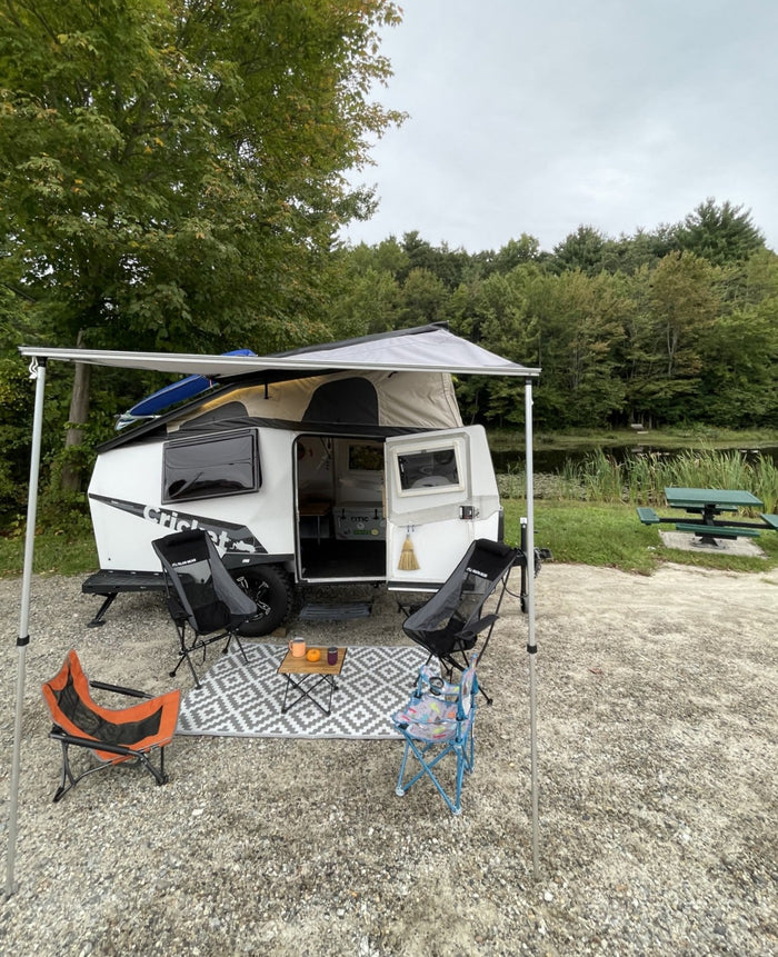 perfect for outdoor fun.|Relaxing lakeside with an RV rental setup: white camper