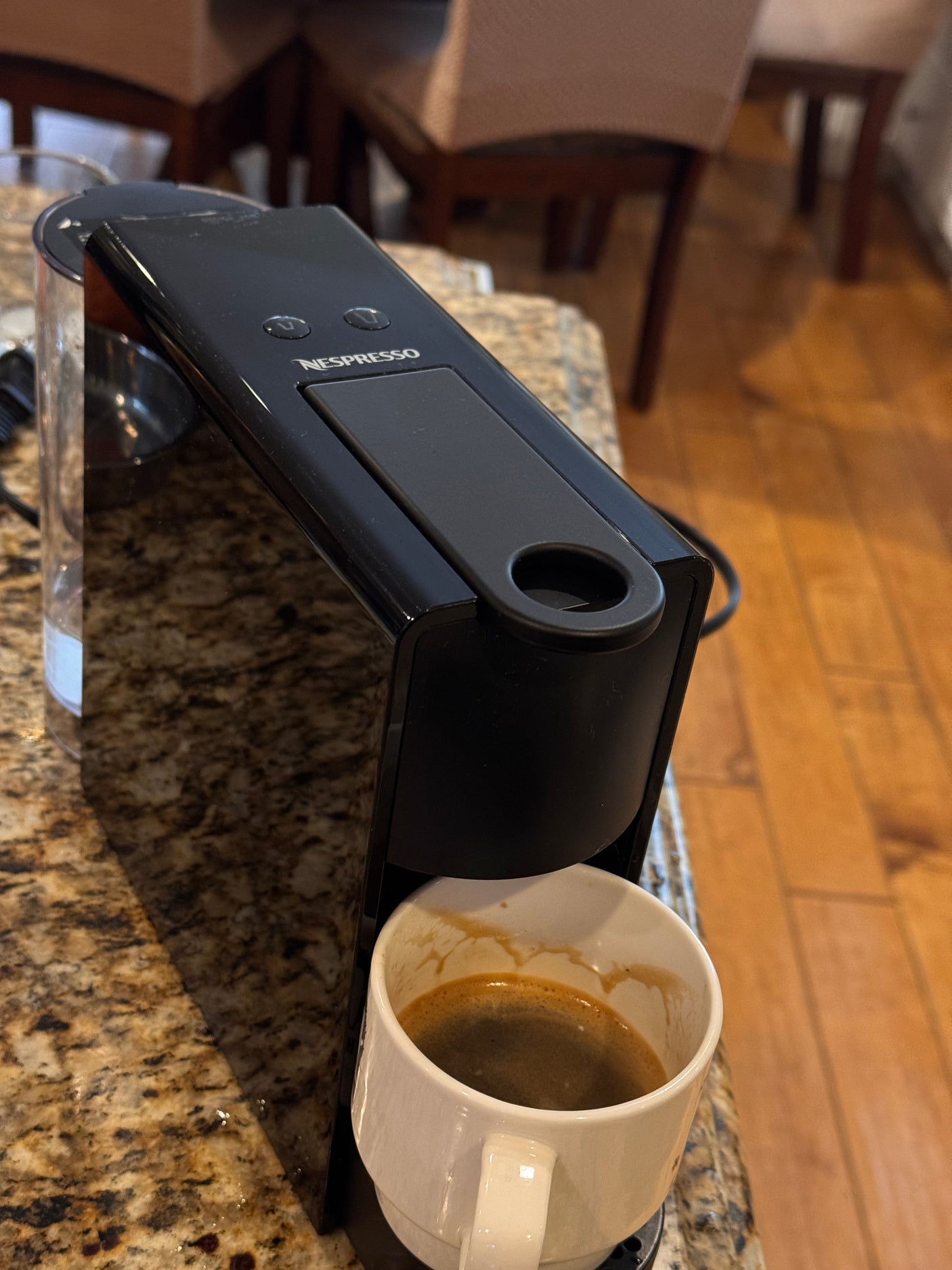 Fresh espresso brewed by a Nespresso machine on a granite countertop, perfect for an RV rental kitchen.