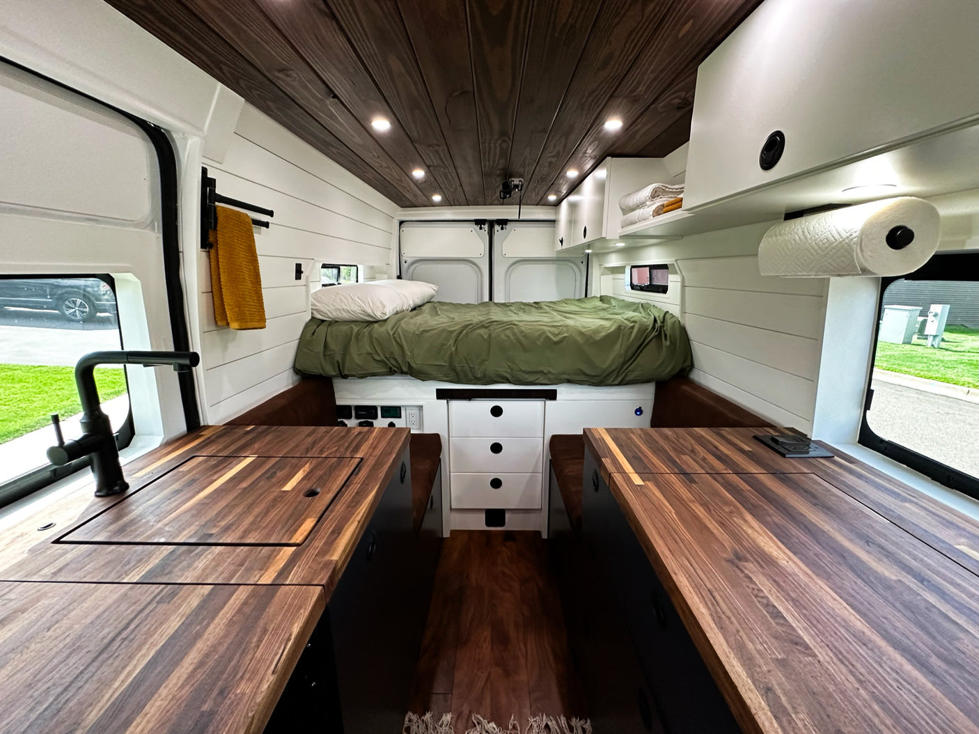 and a functional kitchen with opened cabinets.|RV rental kitchen setup: an open cabinet reveals a kettle