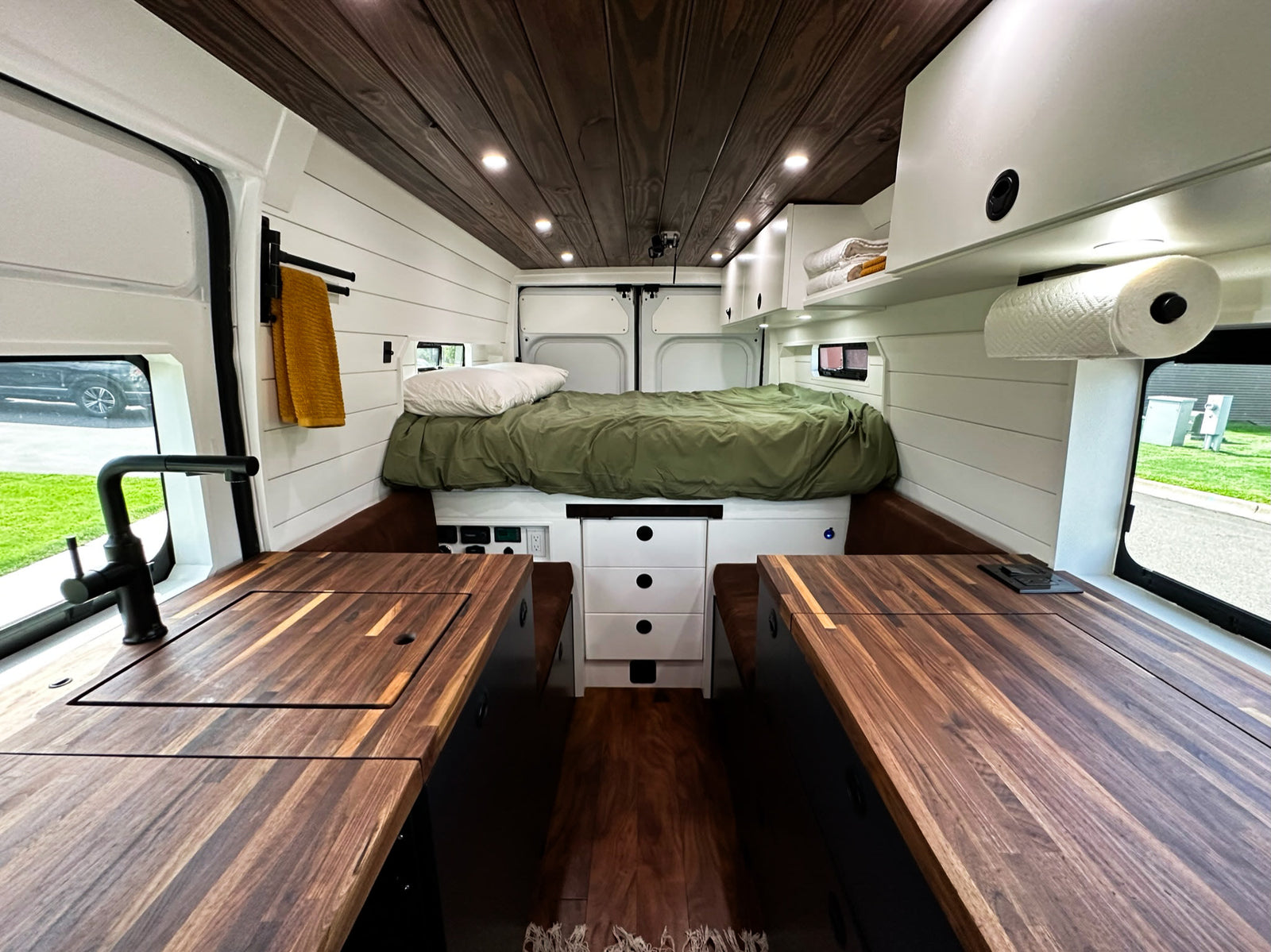 and a functional kitchen with opened cabinets.|RV rental kitchen setup: an open cabinet reveals a kettle