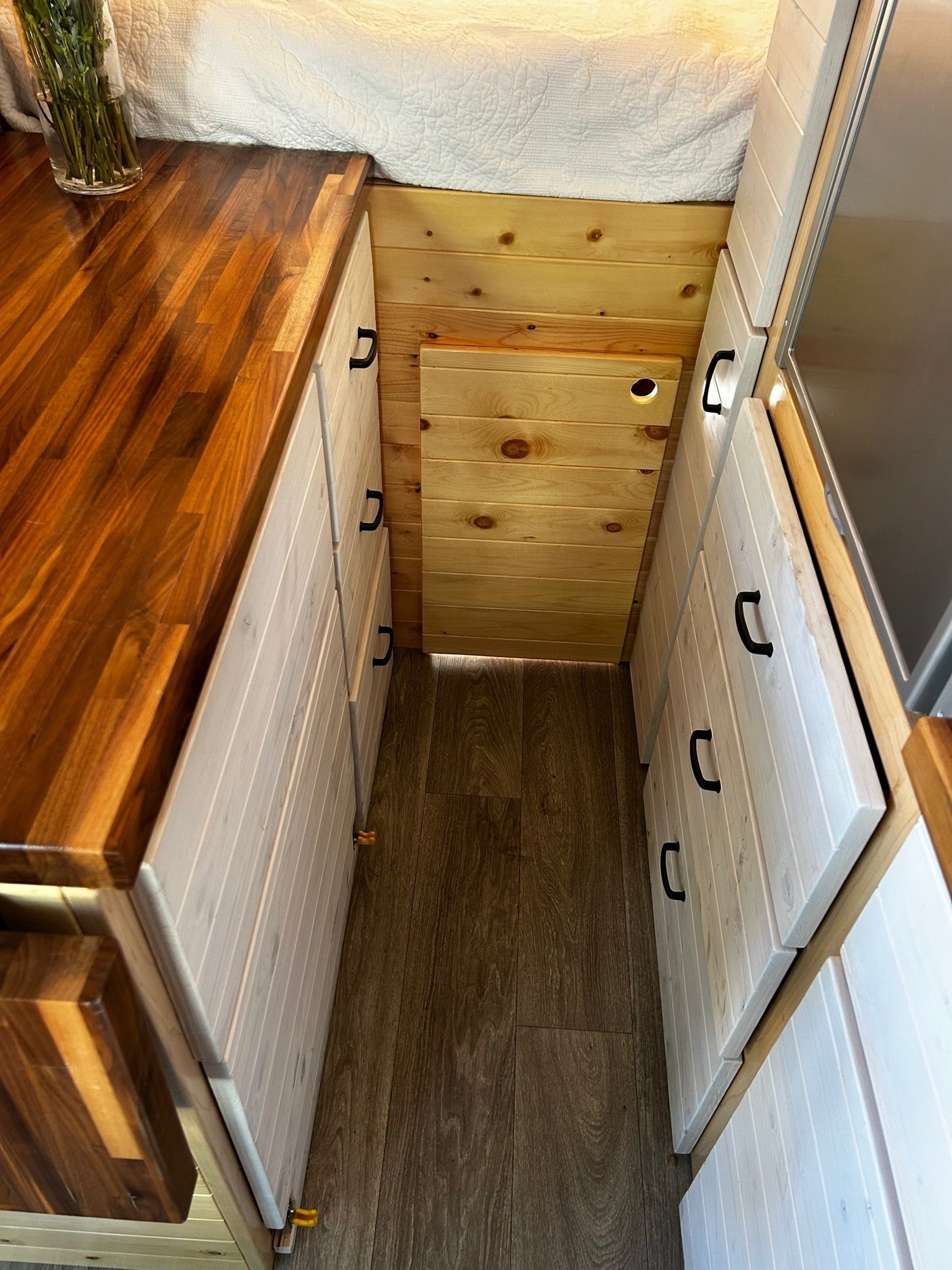 wood-paneled RV rental interior showcasing a compact kitchen