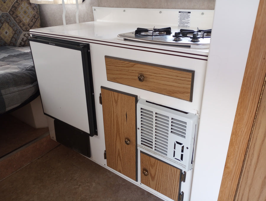and roof AC unit.|Experience camping! An RV rental (Scamp travel trailer) beside a tent & grill setup in a sunny